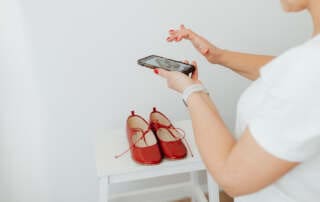 kaboompics Woman takes photos of products she will sell online red shoes