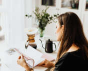 kaboompics The woman drinks coffee and works at her desk