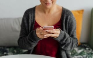 kaboompics a brunette woman works with a laptop and a phone 13809